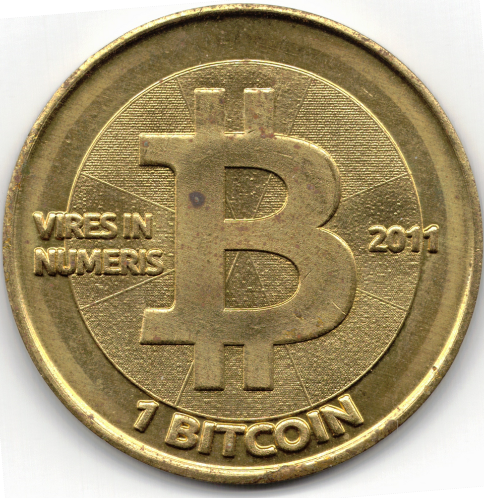 The brass face of a 2011 Casascius one bitcoin